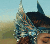 a woman wearing a helmet with wings on her head