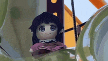 a stuffed doll is sitting on top of a playground slide .