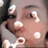 a close up of a woman 's face with bubbles around it