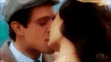 a man and a woman are kissing with a circle in the middle