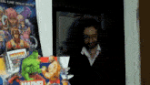 a man is standing in front of a marvel poster