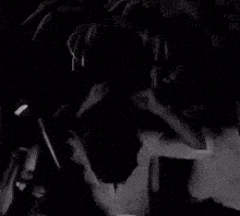 a black and white photo of a person taking a picture of themselves with a camera .
