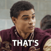 a man wearing a varsity jacket with the word that 's on it