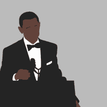a man in a suit and tie stands at a podium with his hand on his mouth