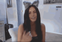 a woman wearing a furry headband with the word manhattan written on it