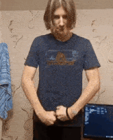 a man in a blue shirt that says outventure