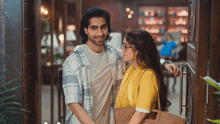 a man and a woman are standing next to each other and smiling .