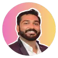 a man with a beard is smiling in front of a pink and yellow background