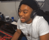 a man wearing headphones and a white t-shirt with the word craftsmith on it