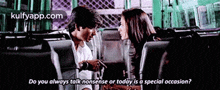 a man and a woman are sitting next to each other on a bus and the man is asking the woman if today is a special occasion