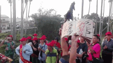 a group of people wearing red hats are holding up a sign that says ' a ' on it