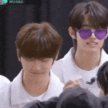 a group of young men wearing sunglasses and white shirts