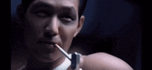 a man is smoking a cigarette with a lighter in his mouth .
