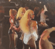a group of women are dancing together in a club .