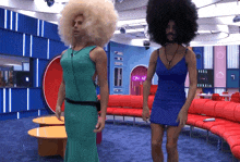a man in a blue dress stands next to another man in a blue dress