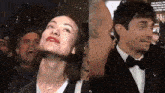 a man and a woman are standing next to each other and the woman is smiling