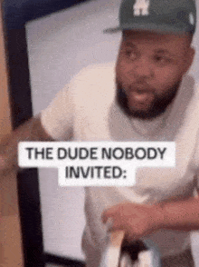 a man in a hat is standing in front of a door with a sign that says `` the dude nobody invited ''