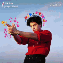 a man in a red shirt is making a peace sign