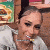 a woman is smiling and saying ahna so funny while wearing a necklace .