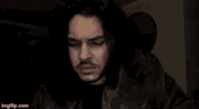a man with long hair and a beard looks at the camera with imgflip.com in the lower right corner