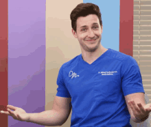 a man wearing a blue scrub top that says dr. michael friedlander d.d. on it