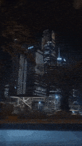 a view of a city at night with a few buildings including one that says ' allianz ' on it