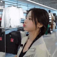 a woman is making a funny face in a store .