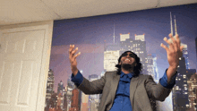 a man in a suit and blue shirt stands in front of a city skyline