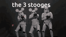 three stormtroopers wearing mickey mouse ears are dancing in front of a sign that says " the 3 stooges "