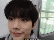 a close up of a person 's face with hyunmin written on the bottom right corner