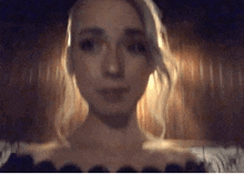 a close up of a woman 's face with a blurry background .