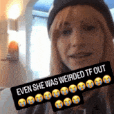 a woman wearing a black hat is holding a sign that says even she was weirded tf out