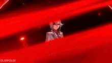 a person is standing in a red light surrounded by red light .