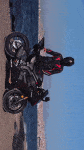 a man is riding a yamaha motorcycle near the ocean