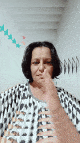 a woman wearing a leopard print shirt gives a thumbs up