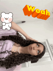 a woman with long curly hair has a sticker of a bear and the word woah above her