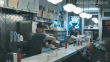 a man prepares food in a diner with a sign that says caught stealing movie