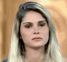 a close up of a woman 's face making a funny face .