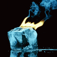 a block of ice is being lit up by a flame .