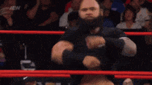 a wrestler in a ring that says aew collision on it