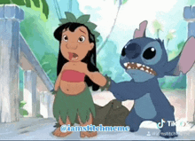 a cartoon of lilo and stitch standing next to each other on a beach