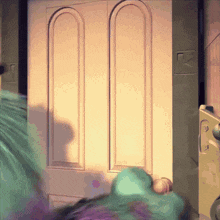 a monster from a cartoon is standing in front of a door with a lock on it