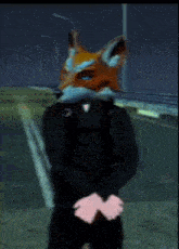a man wearing a fox mask is standing on a street
