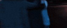 a man in a blue shirt is standing next to a man in a black shirt
