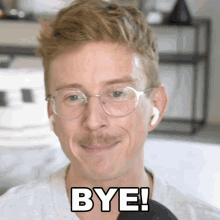 a man wearing glasses and earbuds says bye
