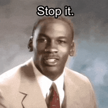michael jordan is wearing a suit and tie and says stop it .