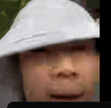 a close up of a person wearing a white hat and sunglasses .