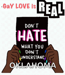 a sign that says ' gay love is real ' and ' don 't hate what you don 't understand oklahoma '
