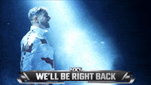 a man in a white shirt is standing in front of a sign that says we 'll be right back