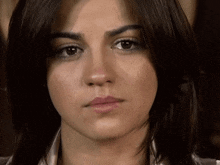 a close up of a woman 's face with a dark background
